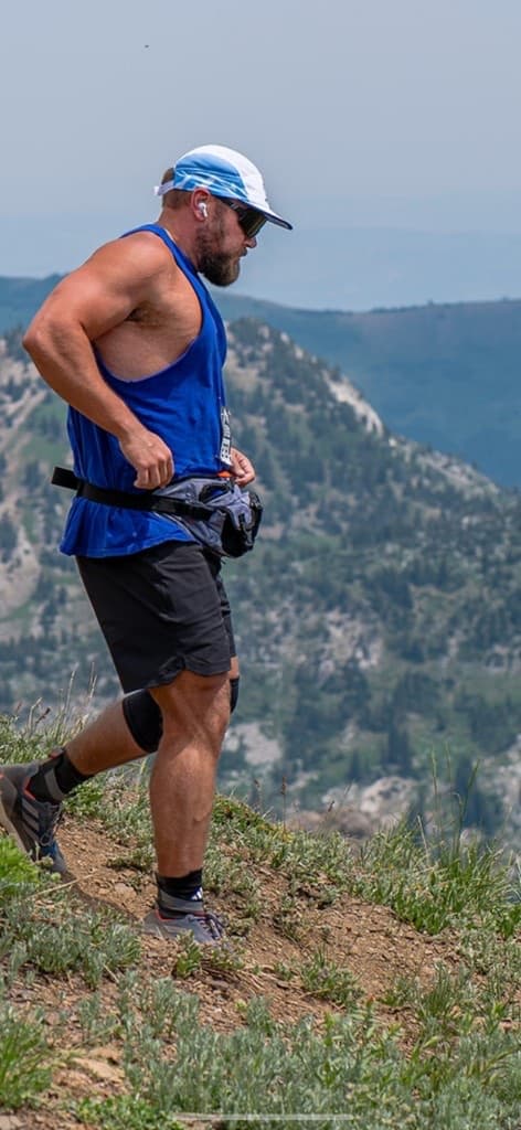 Nick descending a mountain ridge above a valley
